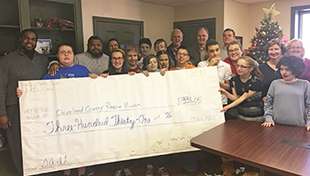 Cleveland County Rescue Mission staff receive donation from Shelby Middle School students.