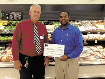Food Lion Store Manager, Carl Rothrock and CCRM Executive Director Michael Gullatte.