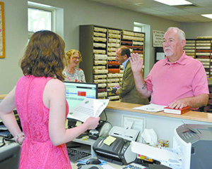 Cailey Speer issuing Commissioner Hutchin\'s Passport Oath.