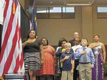 Current members of the Boys & Girls Club lead the audience in the Pledge of Allegiance to the Flag.