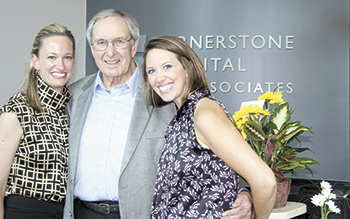 Embraced by the present Cornerstone Dental partners, Cornerstone founder Dr. William Henshaw joins the half century celebration with Dr. Kendalyn Lutz-Craver on the left and Dr. Sara Karner on the right. 