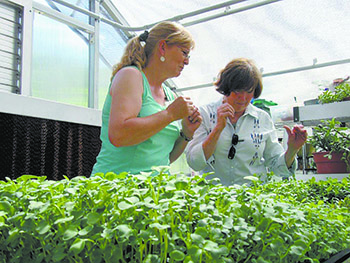 Blanton (right) talks with Beth Bruno, a horticultural therapist at the Shelby Life Enrichment Center. Bruno is the "farmer" for the June 2018 edition of Cleveland County Kitchen. Microgreens are the featured crop.