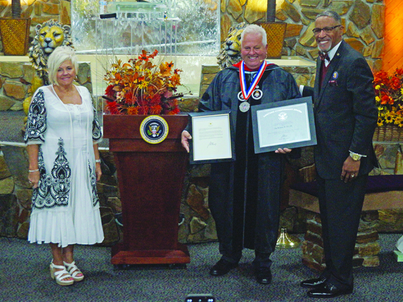 On stage at their church and receiving the Presidential Lifetime Achievement Award on Sunday, Sept. 25, 2022 are (left to right): Mrs. Susan Eng, First Lady, New Life Family Worship Center; Dr. Robert W. Eng, III (with his award and Presidential letter); 