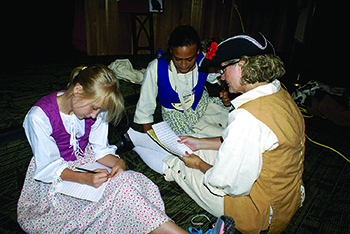  Children\'s author Jenny Cote helps the campers with their stories.