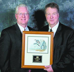 Associate Director of Sales Doug Ladd congratulates Bryan Gamble.