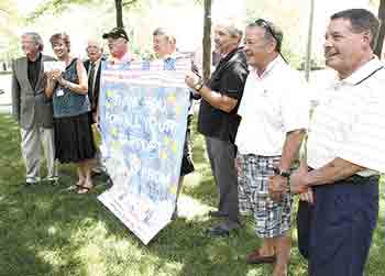 Members of VFW Post 4066 accept a banner of thanks that was created by students in the Exceptional Children Program. (Left to right) Roger Vassey, Dr. Aspel, Ted Whitworth, Gene Ramsey, Steve Conner, Jake Gales, Pat Spangler, and Allen Gold. Photos provid