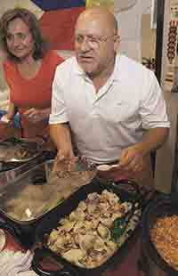 Jzabell and Krzysztof Jablonski serve Polish food during the International Food Festival.