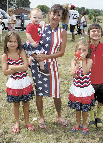 Grandma knows best. Grandma Mia proudly dressed all her grandkids in patriotic attire. Pictured left to right are Alexia, Alisa in Grandma\'s arms, Carma and Nevaeth. After the Lattimore celebration it was off to Grandma\'s house for a family pool party a