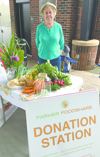 Volunteer, Margie Byars mans the Donation Table during the Foothills Farmers\' Market in Uptown Shelby. Photo provided
