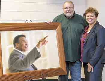 This award winning portrait of Mohammad Ali is viewed by Randy McNeilly, photographer and Nelsa Feaster, principal Graham Elementary School and Board of the Boys & Girls Club. Ali is an alumnus of the Boys & Girls Club of Louisville, KY where he first lea