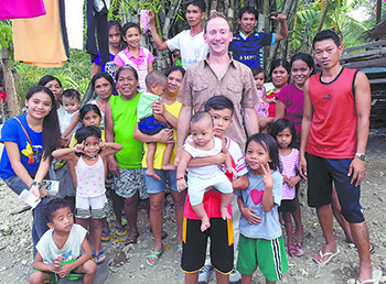 Director Sam Stutts with children and church members from the Philippines.