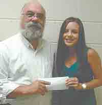 Rev. Roy Byers, member of Number Three Ruritan Club and Pastor of Sulphur Springs Methodist Church, presents Maddie England a scholarship.