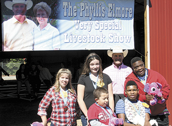North Shelby School students: (l to r) LeeAnn, Sarah (back) Jacob, Tyrick and Jared together with Andy Elemore in front of the Burns High School Barn with their medallions and stuffed toys after being a part of the live stock show.