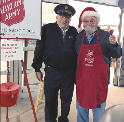 Sgt. Les Ashby, corps administrator for The Salvation Army in Cleveland and Rutherford counties, celebrates with volunteer bell ringer Mike Ledford over the donation of a valuable gold coin placed in the kettle at Shelby Walmart on Black Friday.
