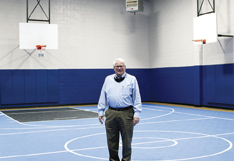 Immediate Past President of the B&GC/CC Dr. Jack Weller stands in the Club's recently repainted Joe and Nell Harand Gymnasium that was made possible by a gift from Shelby Rotary Club Foundation.
