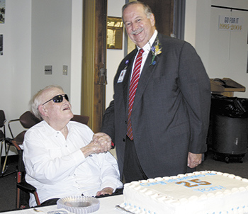 Hoyt Bailey congratulates Dr. Steve Thornburg  at the special reception honoring his 25 years as President of Cleveland County Community College. Mr. Bailey was one of the board members who hired Dr. Thornburg 25 years ago. This was Mr. Bailey\'s last pub