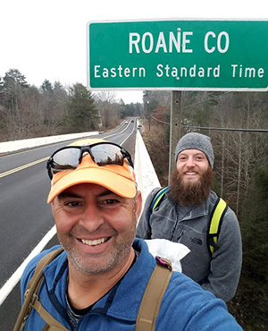 Tommy Dellinger, foreground, with his son Ryan, as they enter the Eastern Standard Time Zone in Roane County, Tennessee. Ryan joined his dad on part of his journey across the United States.