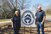 Melanie and Mark Burr, who manage and operate the Totally Free Clothes Store in Shelby, standing beside their sign advertising who they are and what they do. The store is located at 318 Gidney Street. (photos by Michael E. Powell/CF Media)