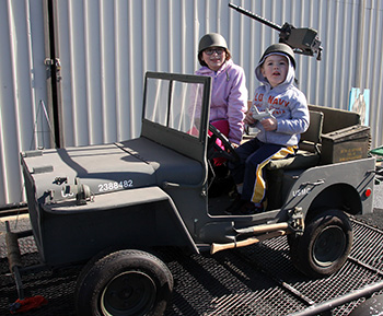 Landon Dycus and Ashlynn Snead pose for a photo in a replica of a 1941 Willis Jeep