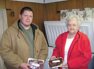 Ethan Winkler, Burns FFA Chairperson of The Triple H Committee (Hunters Helping The Hungry)  with U-CAN of Lawndale Volunteer, Sherry Lee. They are holding packages of processed and frozen deer meat. 