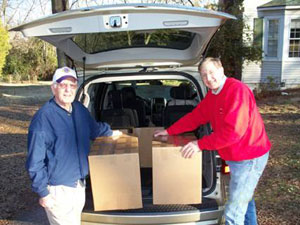 Lion  J.D.  Baldree  (left)  helps  Mayor  Ted  Alexander  load  eyeglasses  for  Nicaragua.