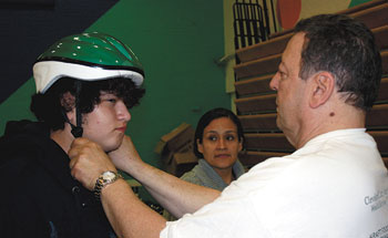 Alex, 13,  is given a perfect fit by co-chair Chris Hundley.