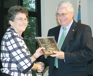 Board Member, Faye Burton presents current President  Jack Weller, the â€œVolunteer Of The Year Awardâ€.