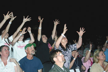 The crowd reaches out for donated stuffed animals that were tossed out.