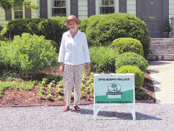 Ms. Claudia Seagle standing in front of her home at 908 Hawthorne Rd.