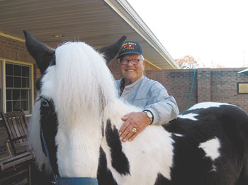 World War II veteran Grady Walker welcomes one of many animals that visit Life Enrichment as part of its goal to bring the community to the center each day.