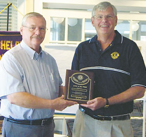 Lion  Jim  Holland,  left,  presents  the  Lions  of  the  Year  award  to  Dave  Titus.