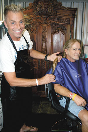 Joseph Lovelace shows Jody Edwards hair that is about to be donated.