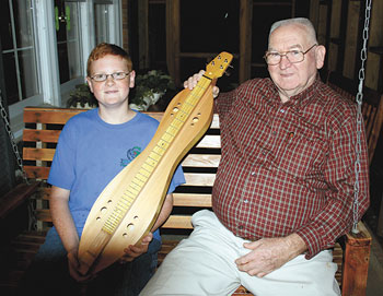 Bradley and Paw Ray show off his handmade dulcimer.