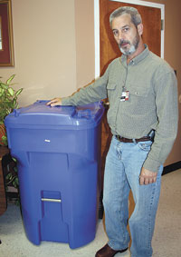 Danny Darst, Shelby Public Works Director,  is pictured with one of the new color coded blue recycle rollaways. The program begins in January 2012.