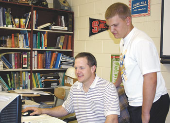 Luke Beam, looks over project numbers with Colby Creswell, Chairman of the Burns FFA â€œHunters Helping the Hungryâ€