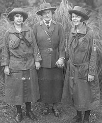 An old photo showing two Girl Scouts with founder Juliette "Daisy" Gordon Low (in center). The first Girl Scout troop meeting was held with 18 girls in Savannah, Georgia.