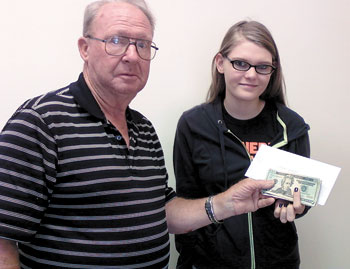 Dawn Loggins is presented $750 from Arnold Ledford