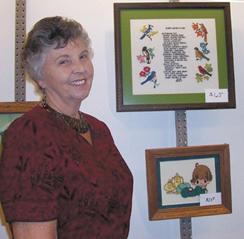 Renee's Mother, Margaret is pictured with Renee's needlepoint work.