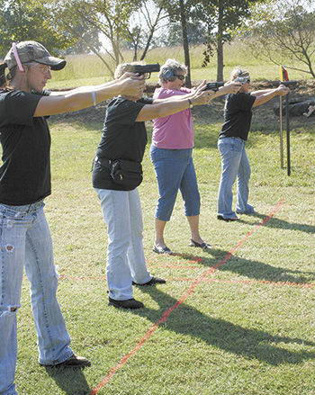 Jodi McCraw, Geneva McCraw, Kathy Petrov and Meggie McCraw take aim as they practice with their sidearms.