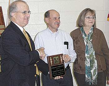 Gary Hastings, left, presents the Carolina Farm Credit Excellence In Agriculture 2012 Award to Loyd & Sara Lewis of Lewis Farms in Fallston, NC.