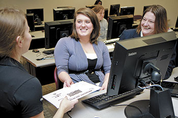 Shown here (left to right) Chelsea Wilbourn, GWU Grad Student receives help on her taxes from Taylor Hyslip, Gardner-Webb Freshman and SIFE (Students in Free Enterprise) President with Denise Smith, Assistant Professor of Business at GWU. 