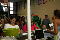 Attendees at the Revive Church Back-to-School Bash sign connections cards.