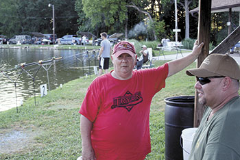 In hopes to win some prize money, John Queen (left) and Wade Tyndall wait for a giant carp to take their bait. Johnâ€™s been fishing at Midway forty-two years and Wade for eight.