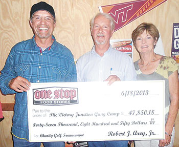  Kyle Petty accepts a check for $47,850.18 from Robert and Candy Arey.