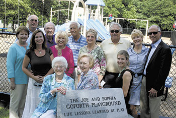 Sofie Goforth is surrounded by family members as she embraced  the permanent marker of the new playground. 