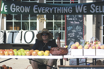 Dustin Smith of Country Produce in Belwood provides fresh, locally grown produce to shoppers on Saturday morning in downtown Kings Mountain.
