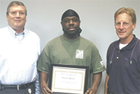 Mario Moore, center, General Manager Robert McBride, left, and Business Unit Manager Phil Leise, right.