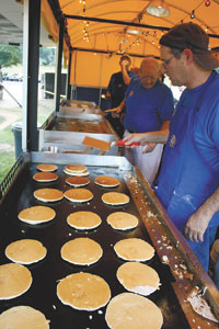 Flapjack chef, David Chadwick works one of the six grills on the Kiwanis Pancake Express wagon.
