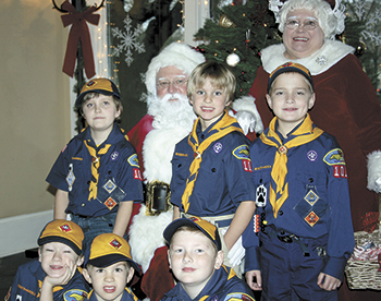 Taking time out to visit Santa and Mrs. Claus are Troop 101 Cub Scout Wolves, (front row) Ford, Turner and Cameron, (back row) Thomas, Lawson and Hayden.