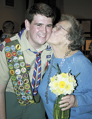 New Eagle Scout, Josh Stevens, gets a congratulatory kiss from a special lady, his Granny!